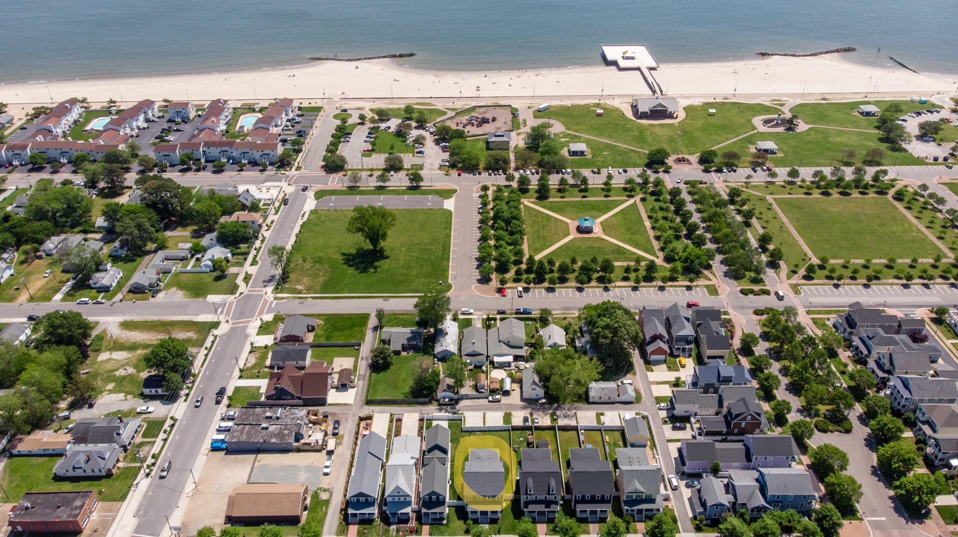Highlighted aerial view of a home in a coastal neighborhood with beach access.